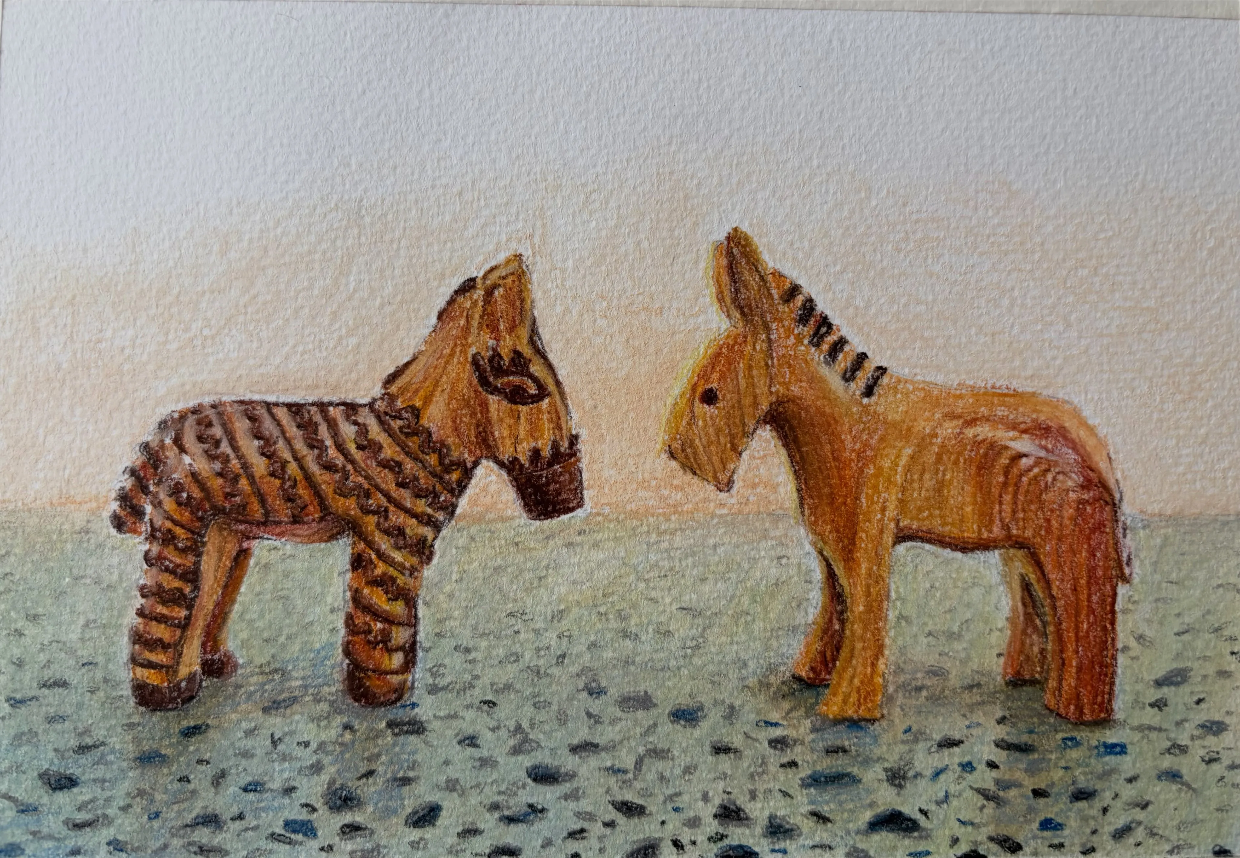 Two small wooden toy animals, one carved with stripes, facing each other on a speckled surface